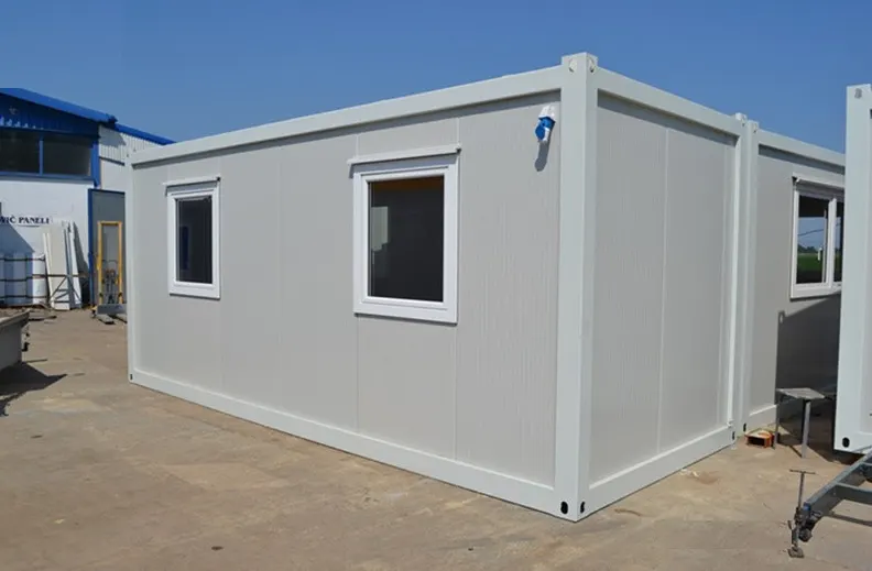 Grey steel modular cabin with windows placed on site